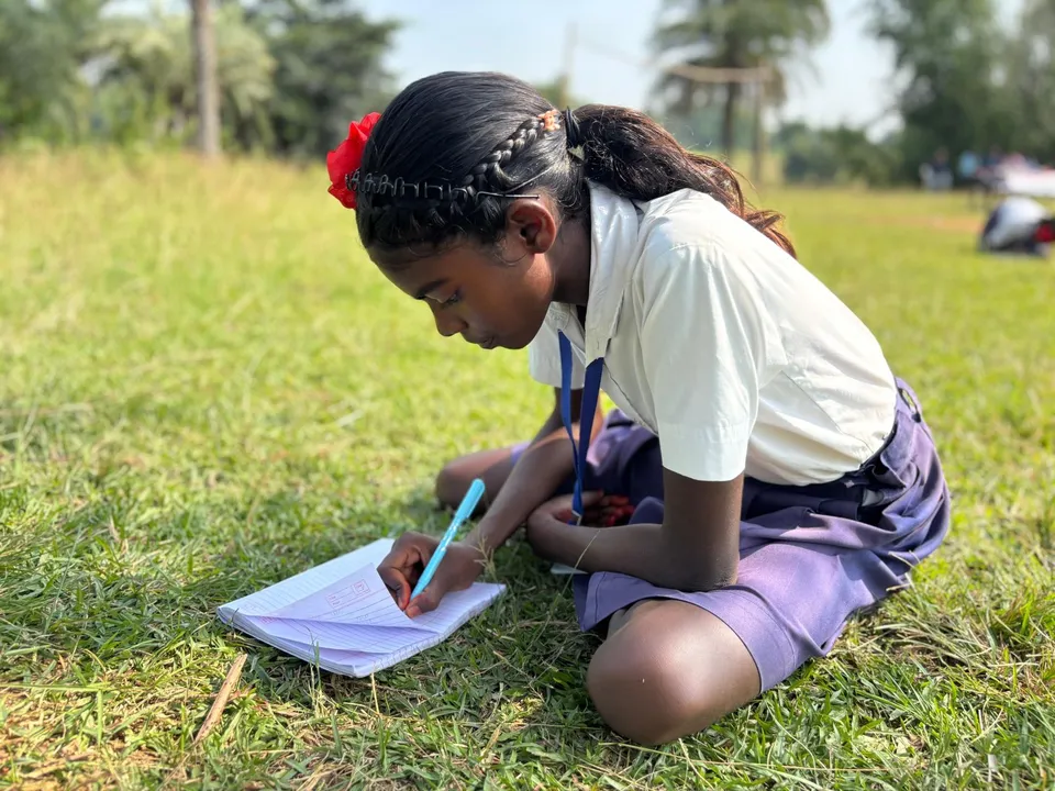 Student writing in book